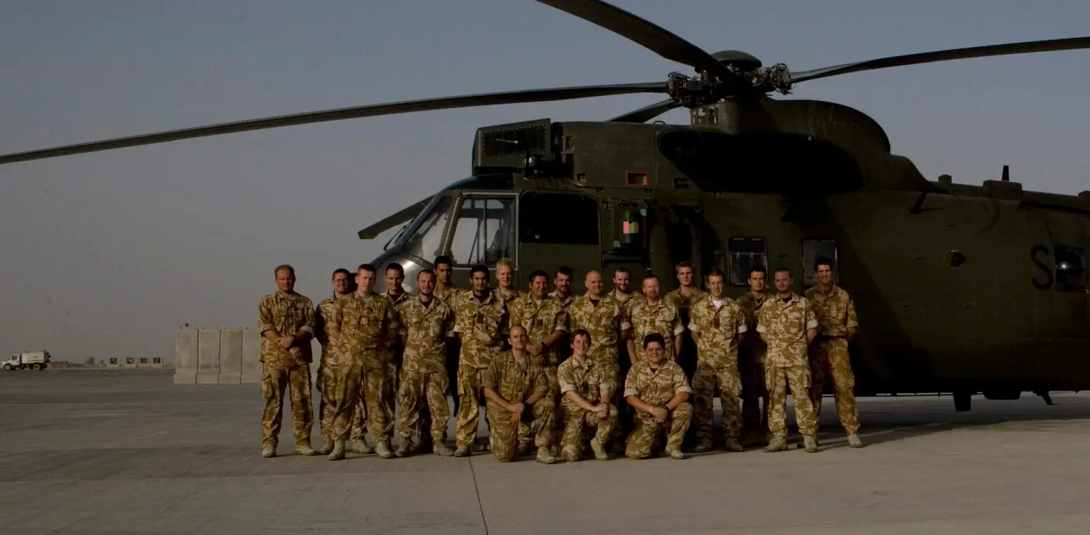 A picture of Mark Lavallee in Afghanistan in front of a Seaking helicopter