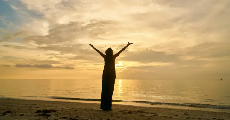 A woman embrace life on a beech from the post Energize Your Day: A Practical Guide to Boosting Vitality and Confidence